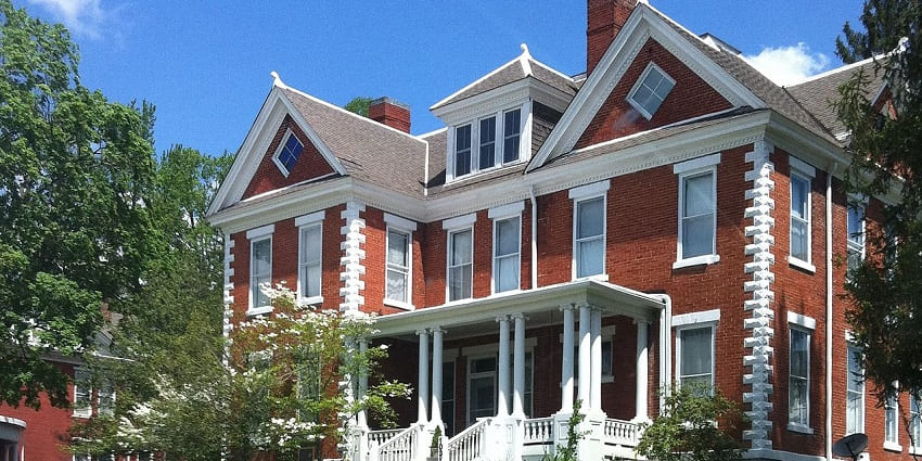 Historic houses with wraparound porches showcase 19th-century charm and architecture.
