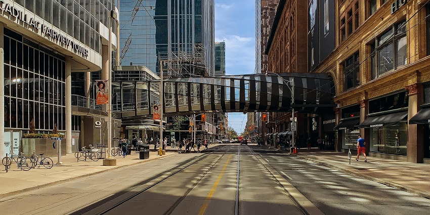 Different types of travelers in Toronto managing daily costs and experiences.