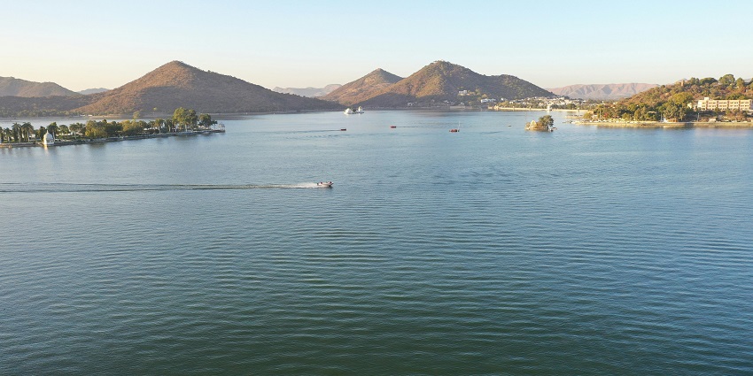The Udai Sagar lake, surrounded by greenery and birdlife, perfect for a scenic getaway