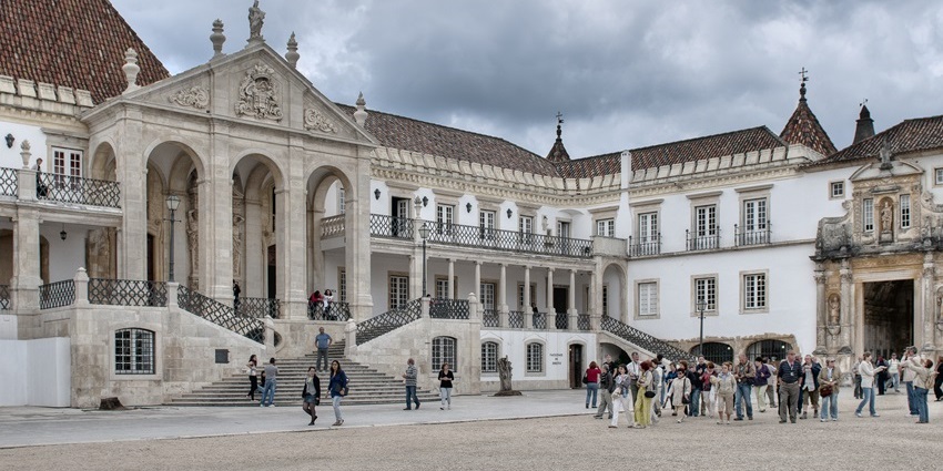 Courtyard and tower of the historic University of Coimbra complex.