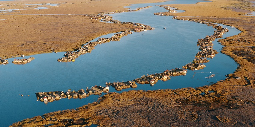 Reed-made floating islands with traditional Uros houses and boats, among the best islands in Peru