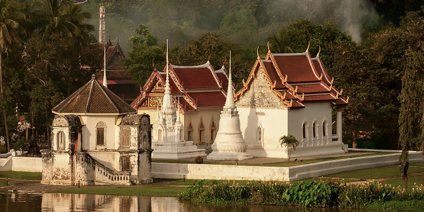 Wat Ubosatharam in Uthai Thani with traditional architecture and a water body, one of the most stunning places to visit in Thailand in July.