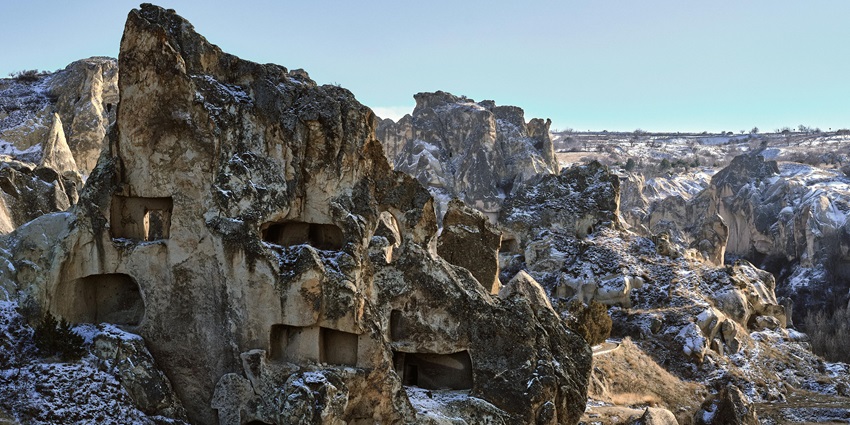 Rock-cut tunnels of Vardzia stretch across a cliffside, one of the monuments in Georgia.