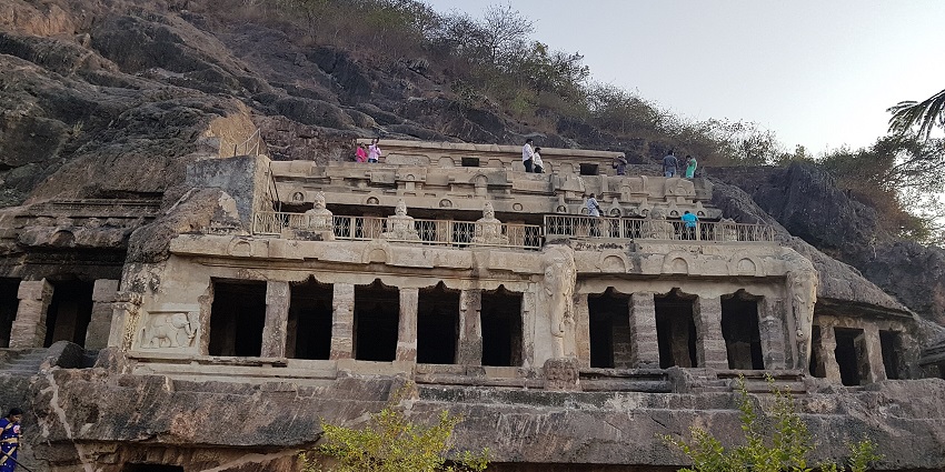 Ancient rock-cut cave temple with carved pillars and sculptures, one of the best places to visit in Andhra Pradesh in March.