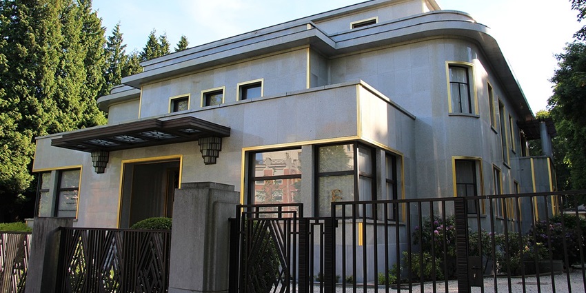 Villa Empain with a unique black entrance gate, modern architecture, and multiple windows