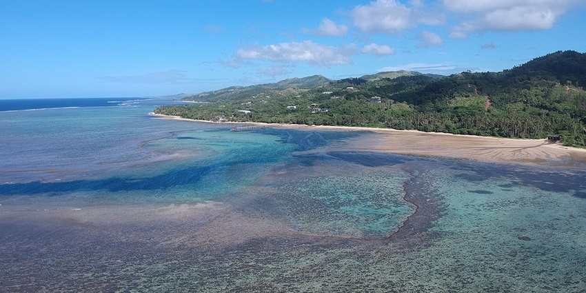 Aerial view of Viti Levu showing lush rainforests, coral reefs, and the bustling capital.