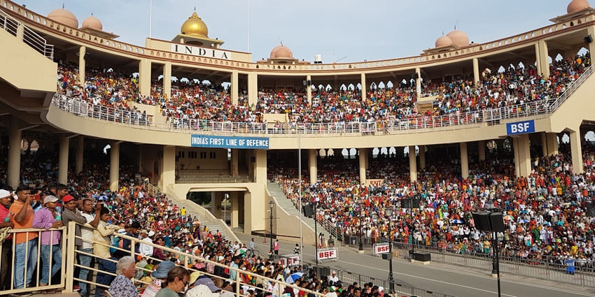 Daily flag-lowering ceremony with energetic patriotic crowds and synchronised military parade, among the best places to visit in Punjab in November.