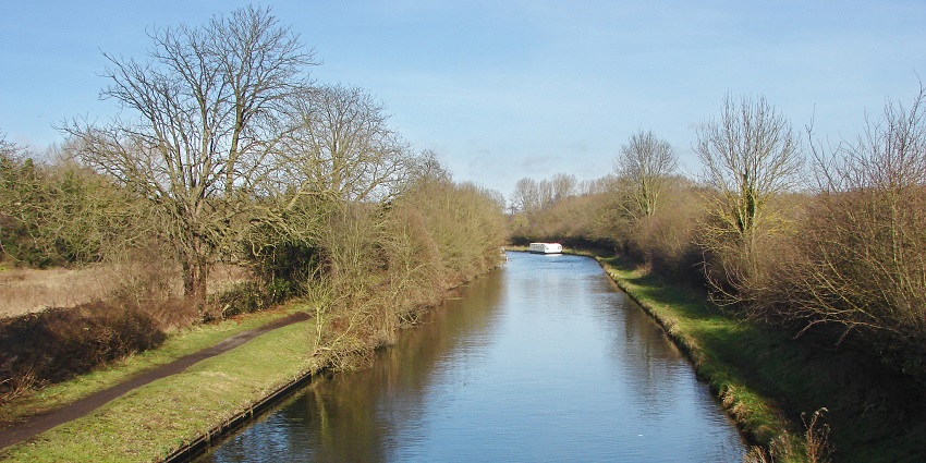 Leisurely walk or bike along canal paths lined with boats, trees, and peaceful waters.