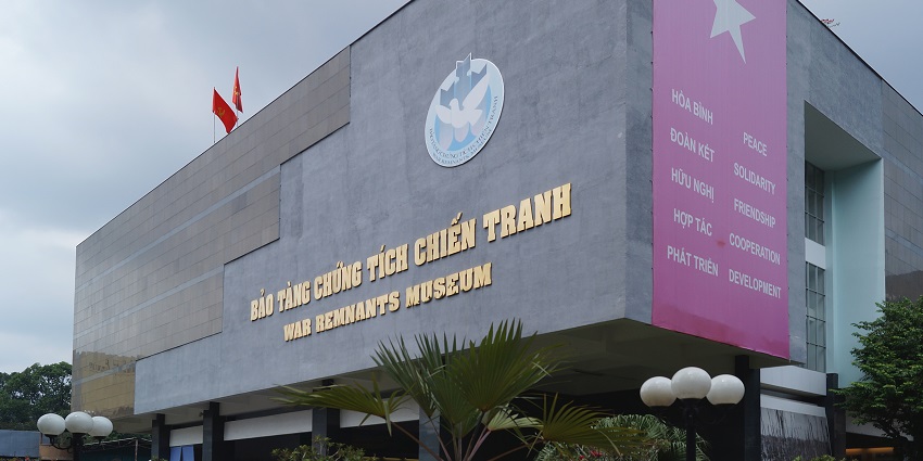 A front view of the War Remnants Museum in Ho Chi Minh City with visitors in daylight