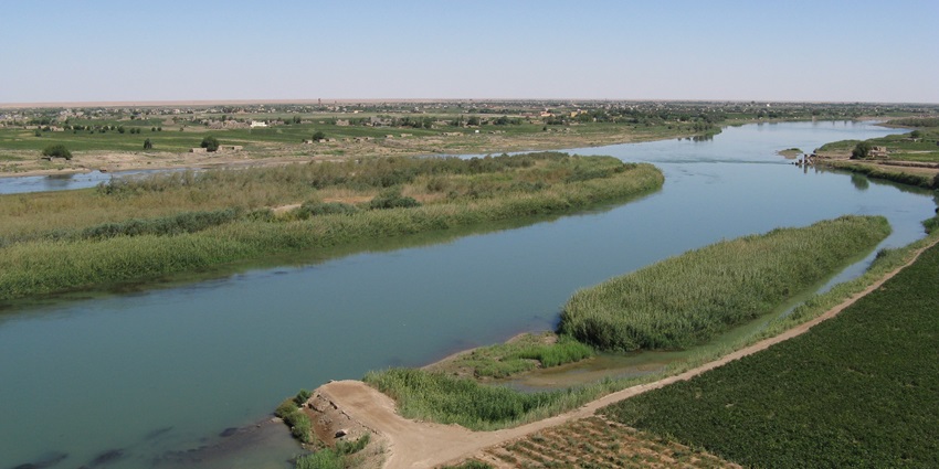 Border island near Iraq with low vegetation and restricted access.
