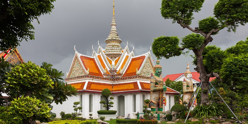 Wat Arun temple with its tall spires decorated in colorful ceramics along the Chao Phraya River, making it one of the important monuments in Thailand.