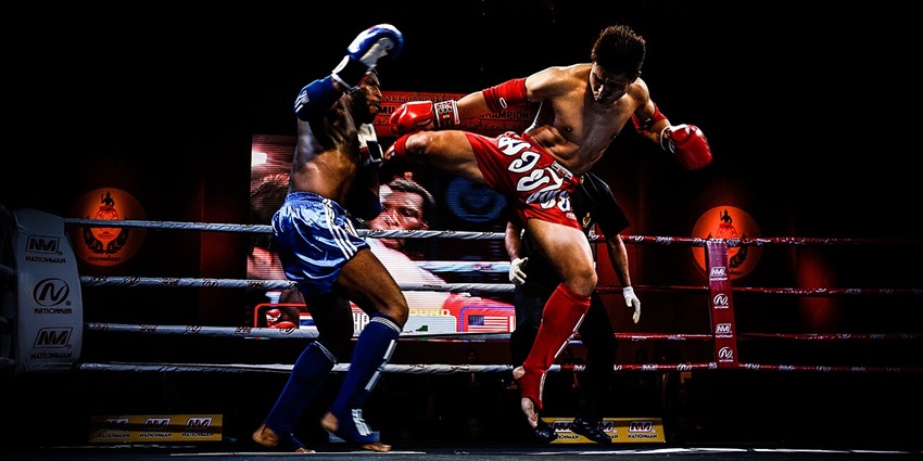 Muay Thai fight between a US fighter and a Burmese opponent, showing skilful action and technique.