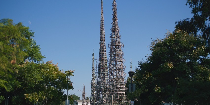Watts Towers of Simon Rodia, with unique architecture, multiple towers, and green trees