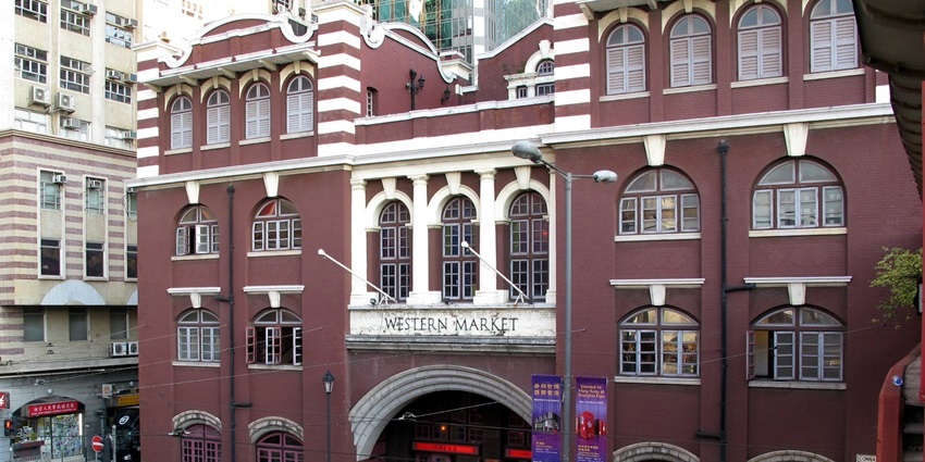 Edwardian-style red brick market building with arched windows and heritage signs.