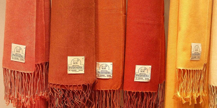 Soft, luxurious pashmina shawl woven from Himalayan goat wool in vibrant traditional patterns, one of the best things to buy in Kathmandu.
