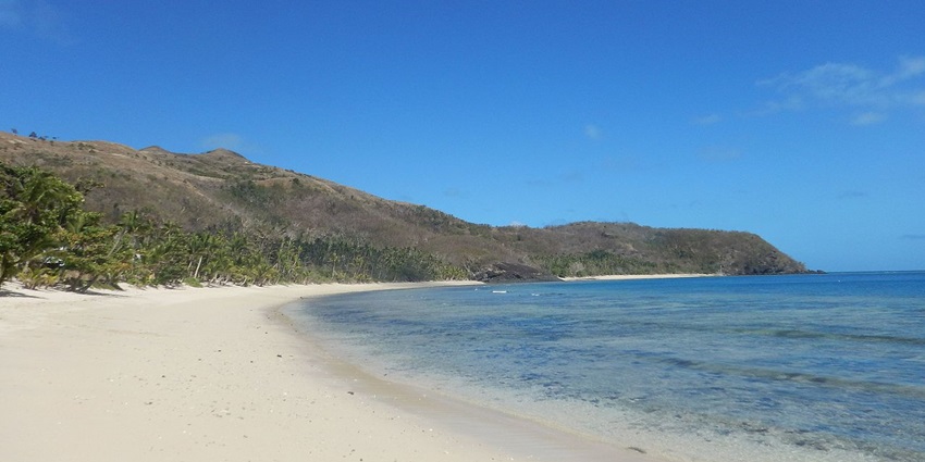 Traditional Fijian villages and volcanic peaks lining the shores of the Yasawa Islands.