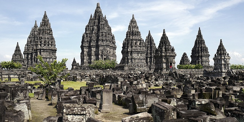 An ancient temple complex, with its towering spires and intricate stone carvings, an iconic historical place to visit in Indonesia.
