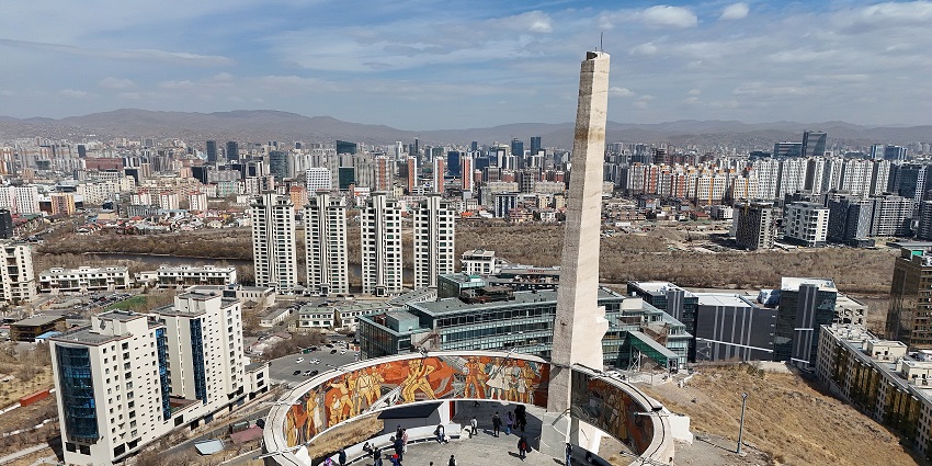 Zaisan Memorial with a tall tower, circular architecture and people inside the memorial