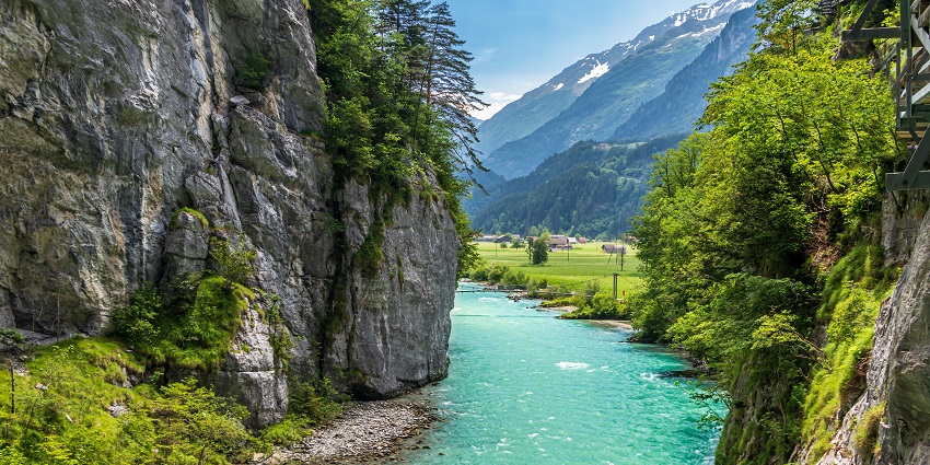 Aareschlucht in Switzerland with a clear water body of a river flowing between two rocky hills.