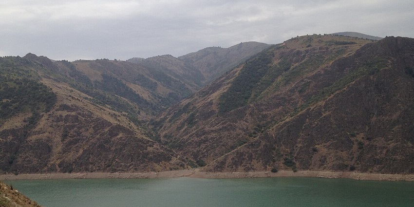 Akhangaran Reservoir with turquoise water and sandy shores, best places to visit near Tashkent.