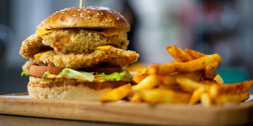 Savoring a delicious burger meal, one of the best things to do in Paphos at night.
