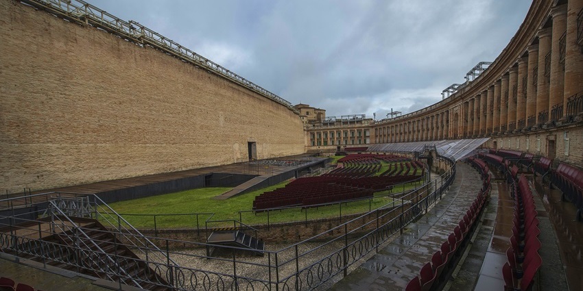 View of Macerata’s Sferisterio with red seats and a grand neoclassical stage façade, one of the best things to see in Macerata Italy.