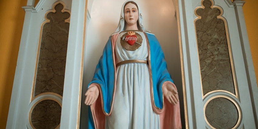Ornate statue of the Virgin Mary in golden robes during a religious procession, one of the things to see in Maiori.