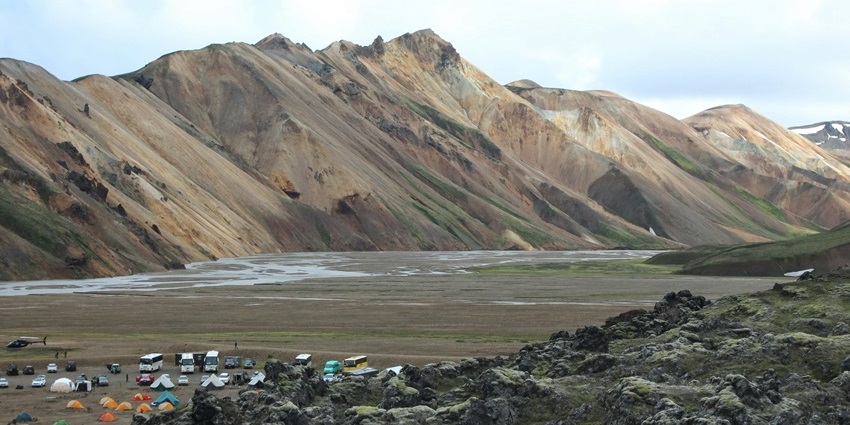 Tents set up at the Landmannalaugar camping site, surrounded by Icelandic mountains.