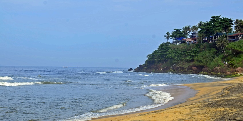 Candolim Beach in Goa, with calm waves and a palm-lined shore, one of the places to visit in Goa near Panjim.
