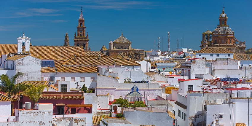 Carmona from above with vibrant houses & buildings, orange roofs, one of the places to visit near Seville.
