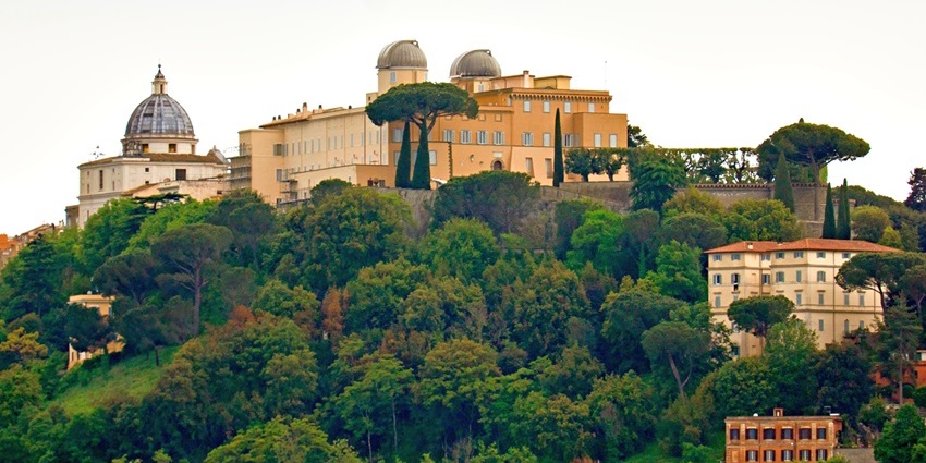 Castel Gandolfo with tall green trees vibrant observatory and Italian buildings places to visit near Rome.