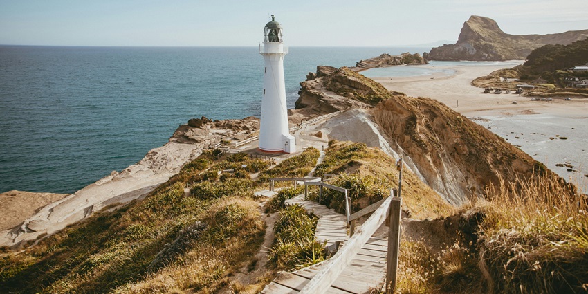 Scenic Castlepoint viewpoint with path to lighthouse, one of the stunning places to visit near Wellington.