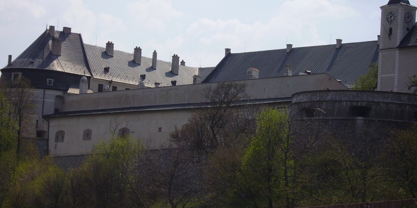 Historic castle with steep slate roofs and clock tower one of the places to visit near Bratislava.