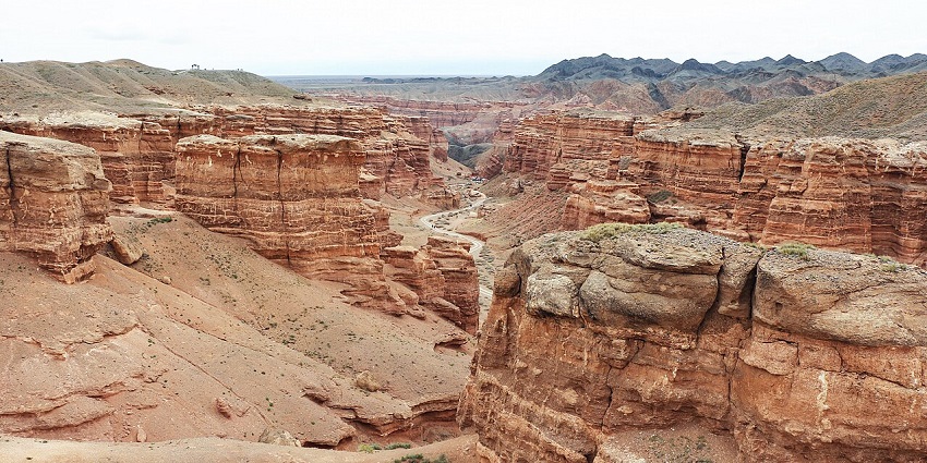 View of Charyn Canyon in Kazakhstan with rugged cliffs and layered red rock formations, one of the best places to visit near Almaty.