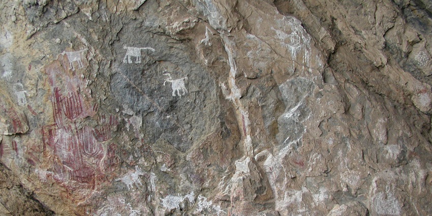 Chongoni Rock-Art Area with faded red and white paintings on the granite rocky surface, one of the places to visit in Malawi.