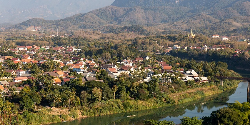 Scenic view from Mount Phousi overlooking Luang Prabang, with rivers and distant hills.