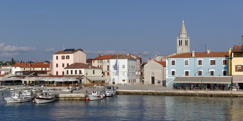Coastal view of Fažana, Croatia, with sea, boats, and waterfront buildings, one of the places to visit near Italy.