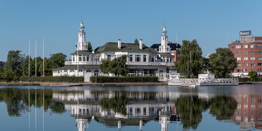 Søpavillonen on Peblinge Lake Denmark with white arches and water reflection.
