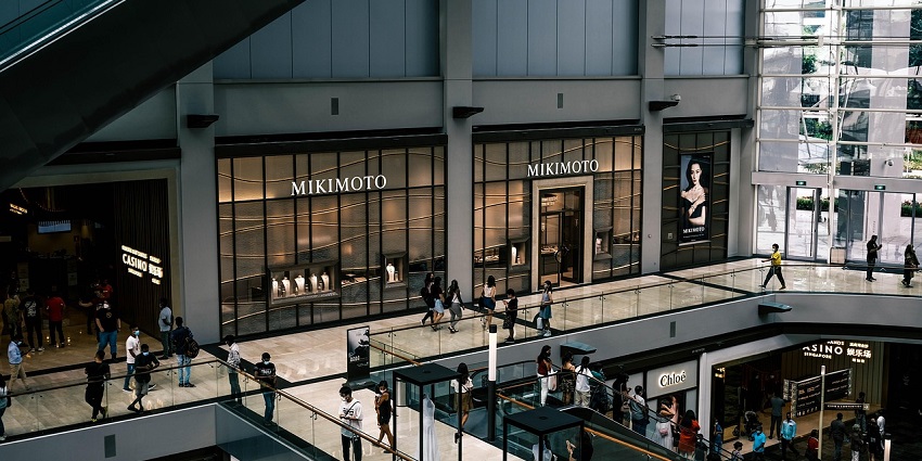 Bright indoor view of Old Town Mall with shoppers and various stores visible.