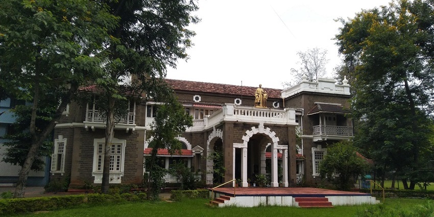 Front view of the historic Don Bosco Youth Centre building, Pune, with white facade under bright daylight sky.