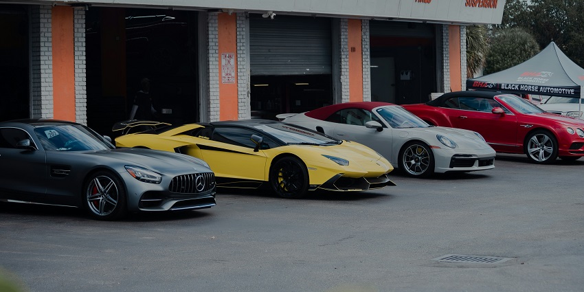 Showroom with luxury sports cars parked inside Monticello Motor Club.
