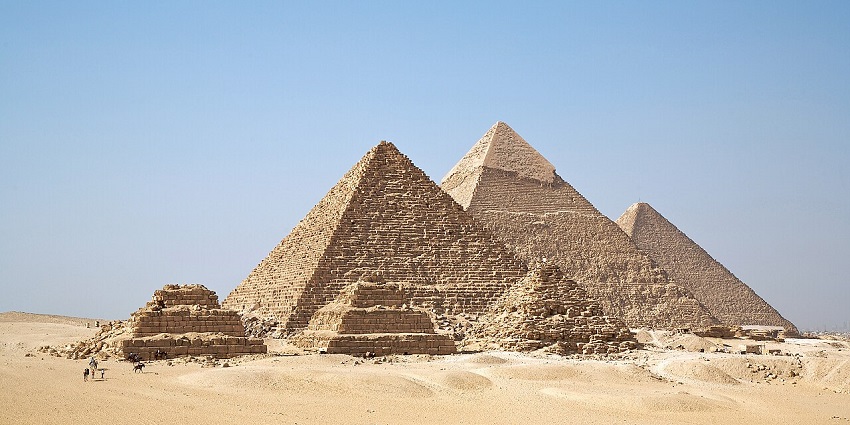 The Pyramids of Giza with desert sands and clear skies, stunning places to visit near Qatar.