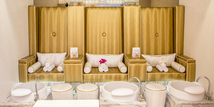 Peaceful spa setting with candles, towels, and flower petals for couple's relaxation.
