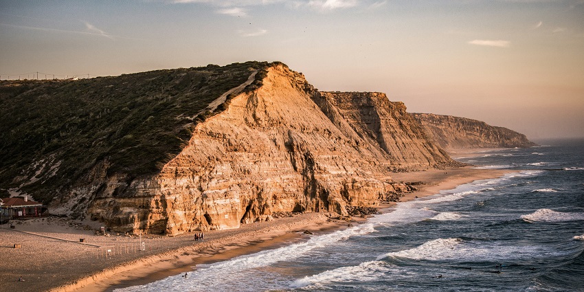 The scenic coastline of Ericeira is one of the charming places to visit near Lisbon, known for its rugged cliffs and sandy beaches.