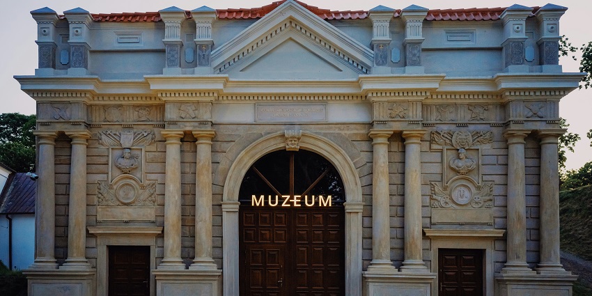 The exterior view of the National Museum of Ethiopia with surrounding trees and clear skies.