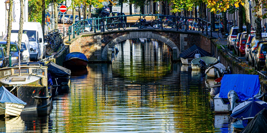 Scenic view of Haarlem canals with historic buildings and calm water.