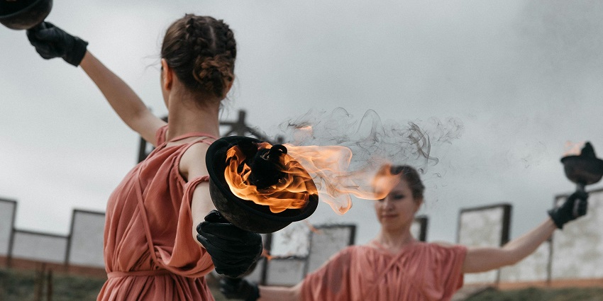 Fire dance performers in traditional costumes showcase cultural movements during the day.