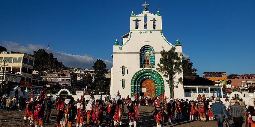 People celebrating Fiesta De San Juan with traditional clothes and festive activities.