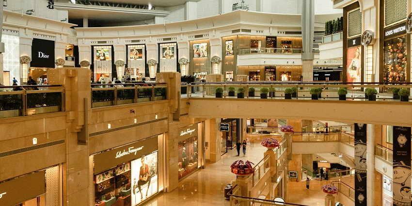 Indoor view of Gateway Mall with shops, shoppers, and bright lighting.