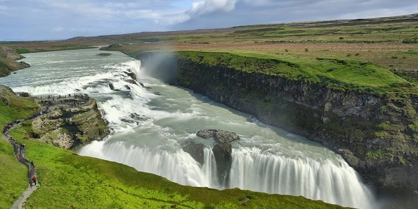 Waterfall flowing through rocky terrain along the Golden Circle trail in Iceland.